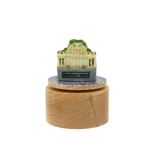 Model of a classical building on a wooden base with 'Karlovy Vary' branding.